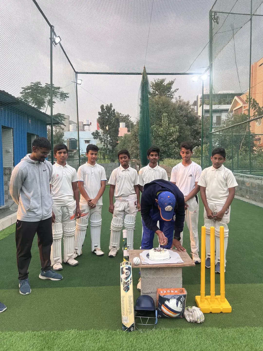 Young cricketers and coach at the practice nets at Coliseo Noble Residency